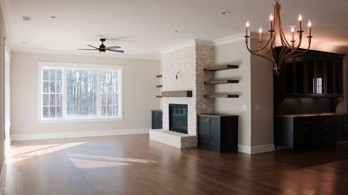 Living room with stone fireplace and hardwood floors