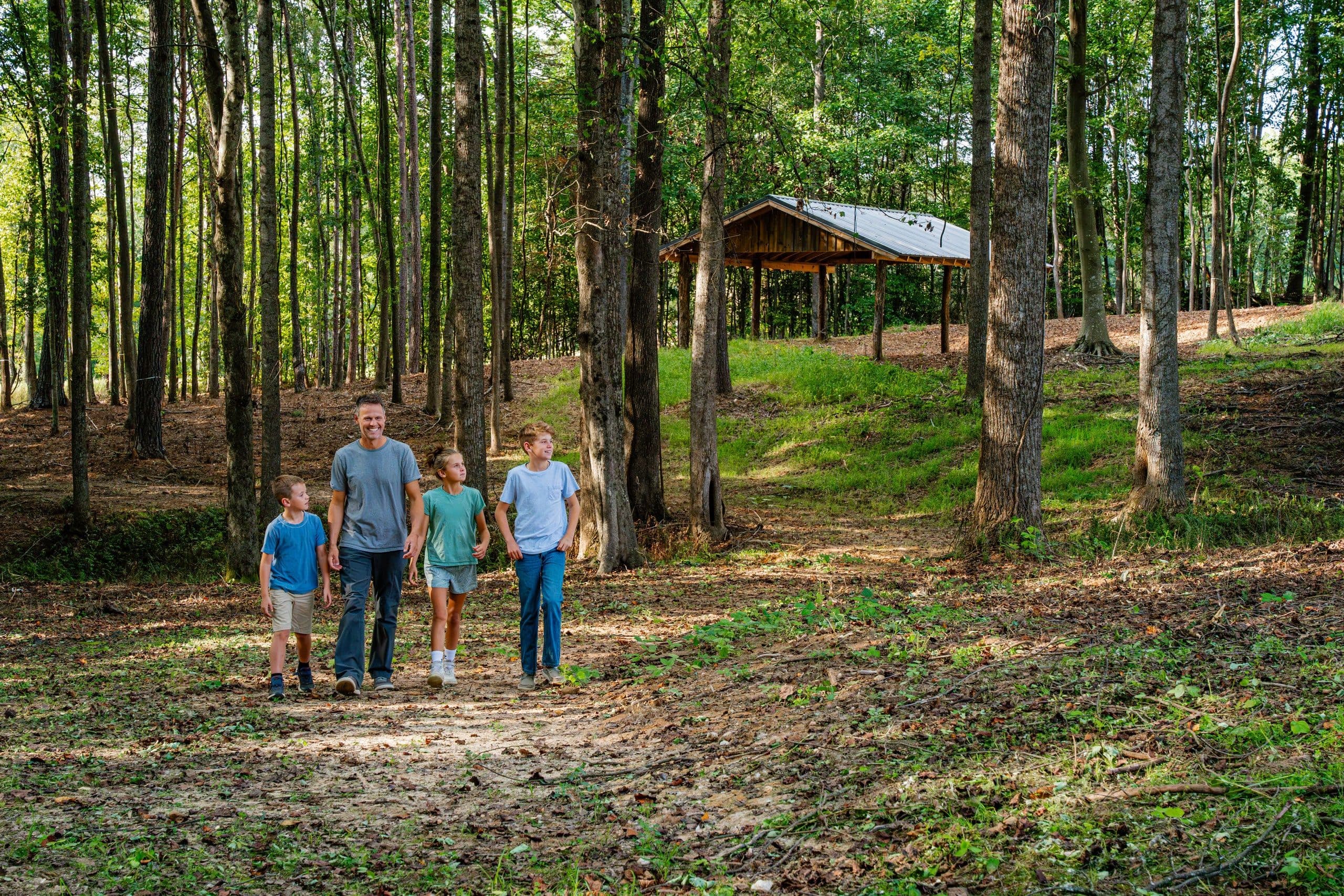 Family walking through forest trails at Longview Carolina