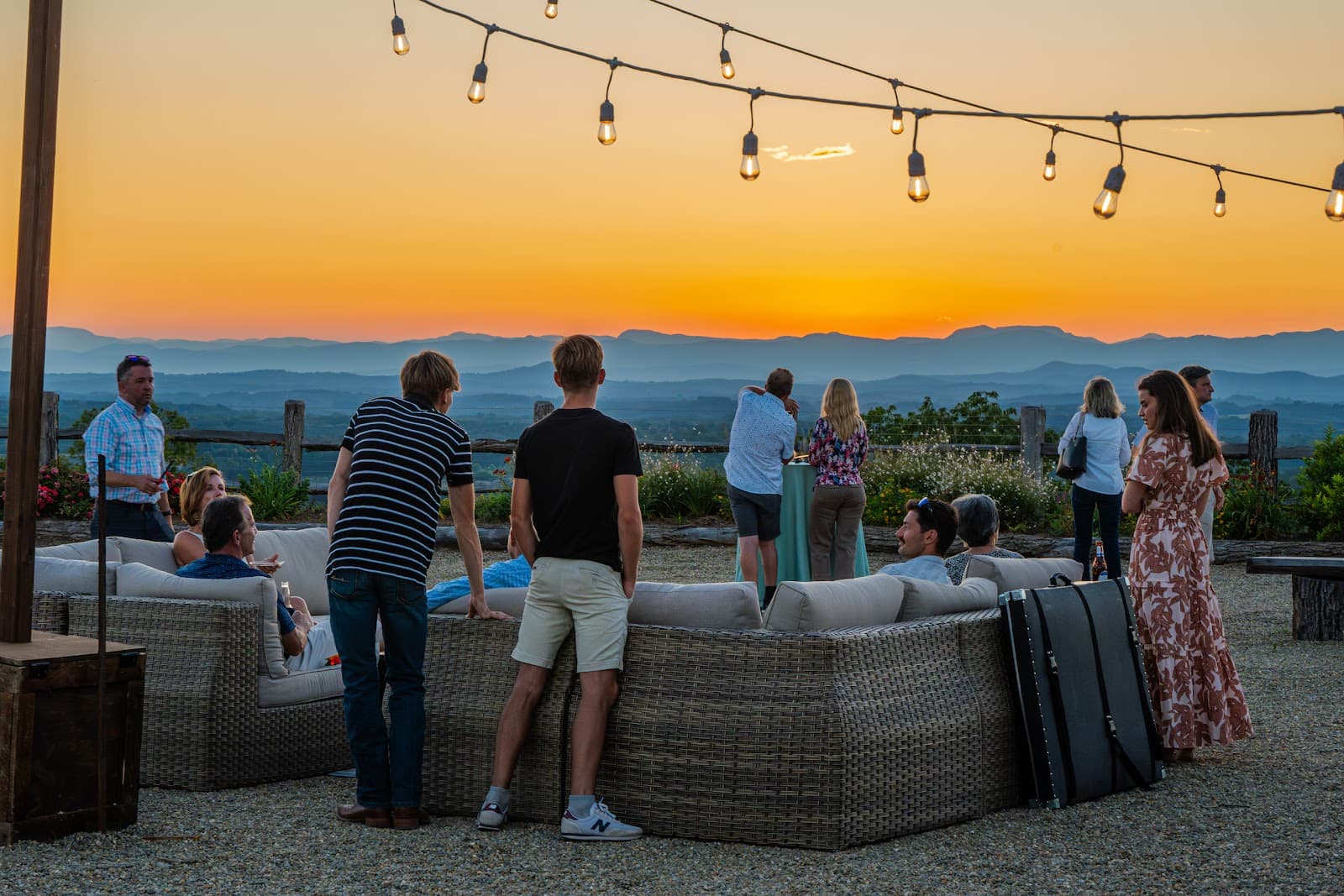 People gathering at sunset on a mountaintop patio at Longview Carolina